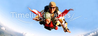 Portrait of two skydivers in action