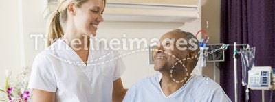 Nurse Helping Patient Sit Up In Bed