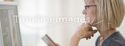Woman using credit card and computer