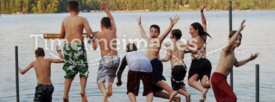 Group of kids jumping into Lake