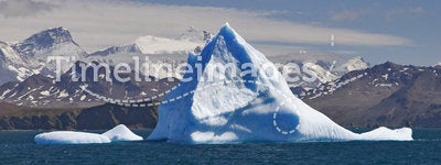 Blue iceberg with land