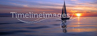 Yacht sailing at sunset