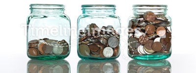 Glass jars with coins - savings concept