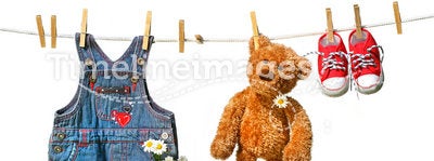 Child's clothes with teddy bear on clothesline