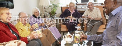 Senior adults having morning tea together