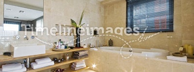 Luxury bathroom with light brown marble