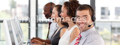 Smiling businessman working in a call center